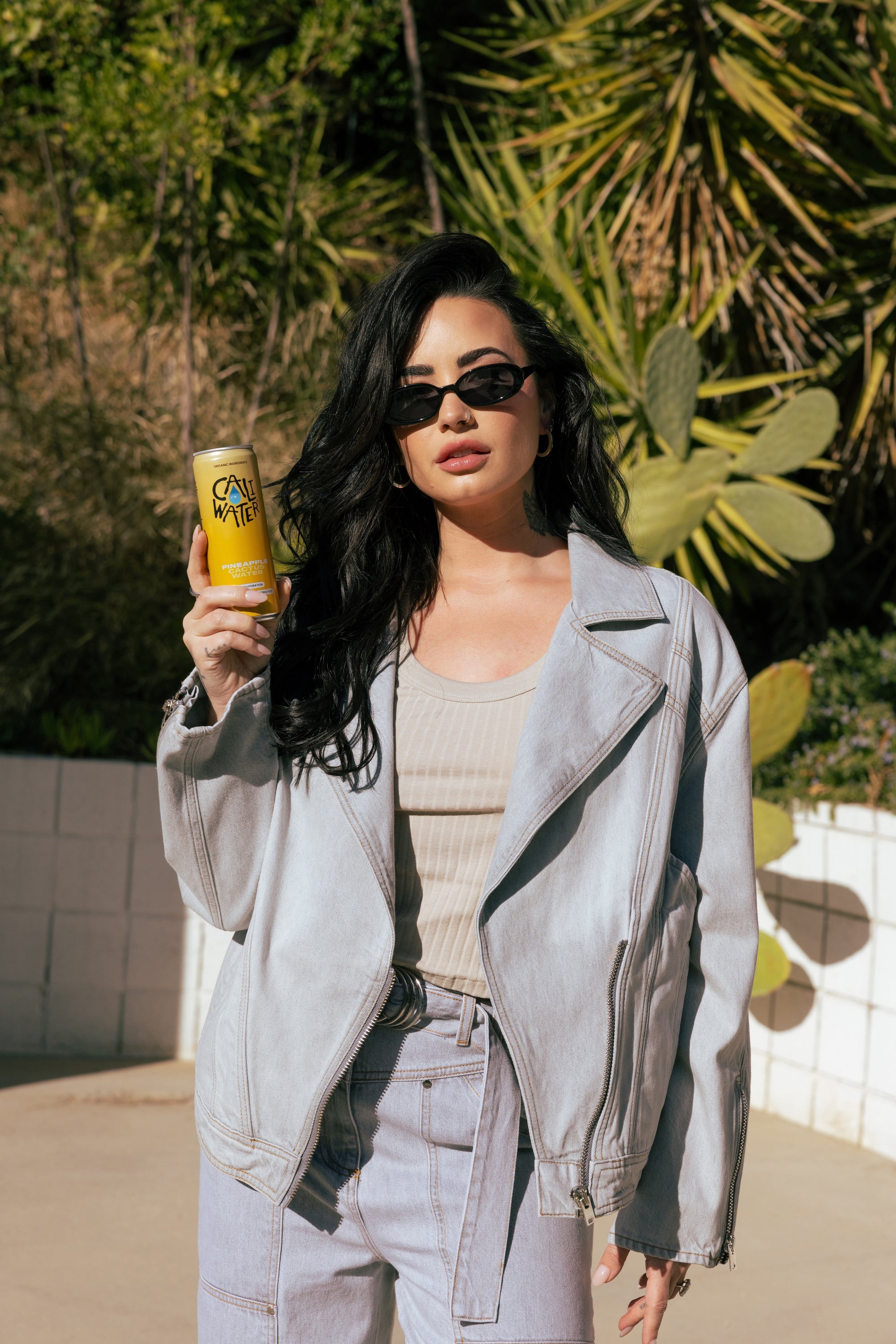 Demi Lovato holding a can of Caliwater