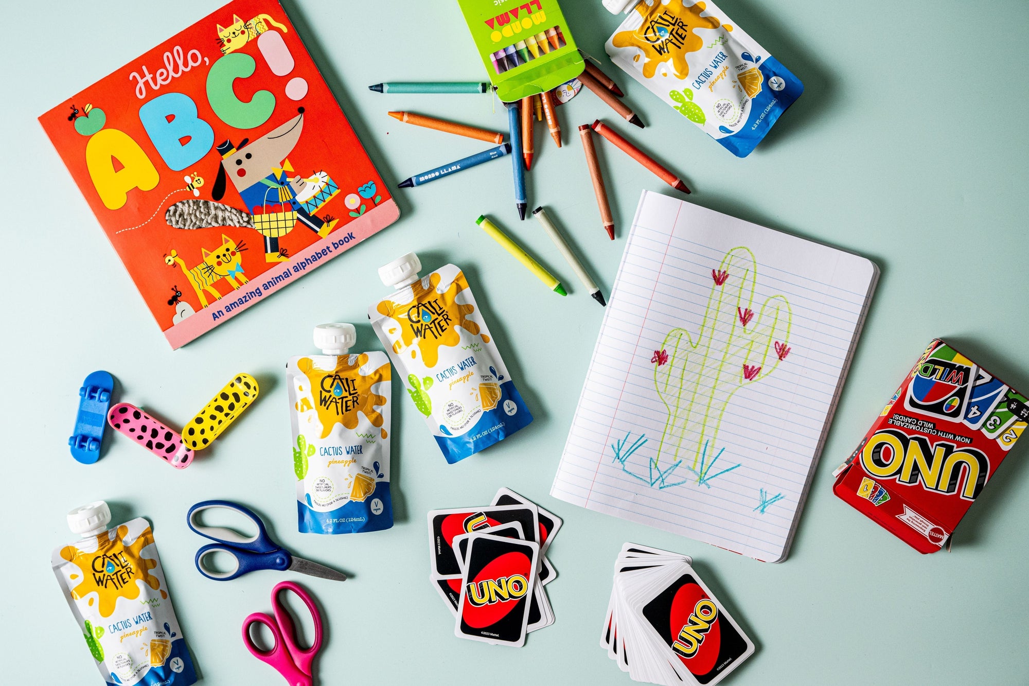 Caliwater Kids pouches on a table with kids' toys and activities