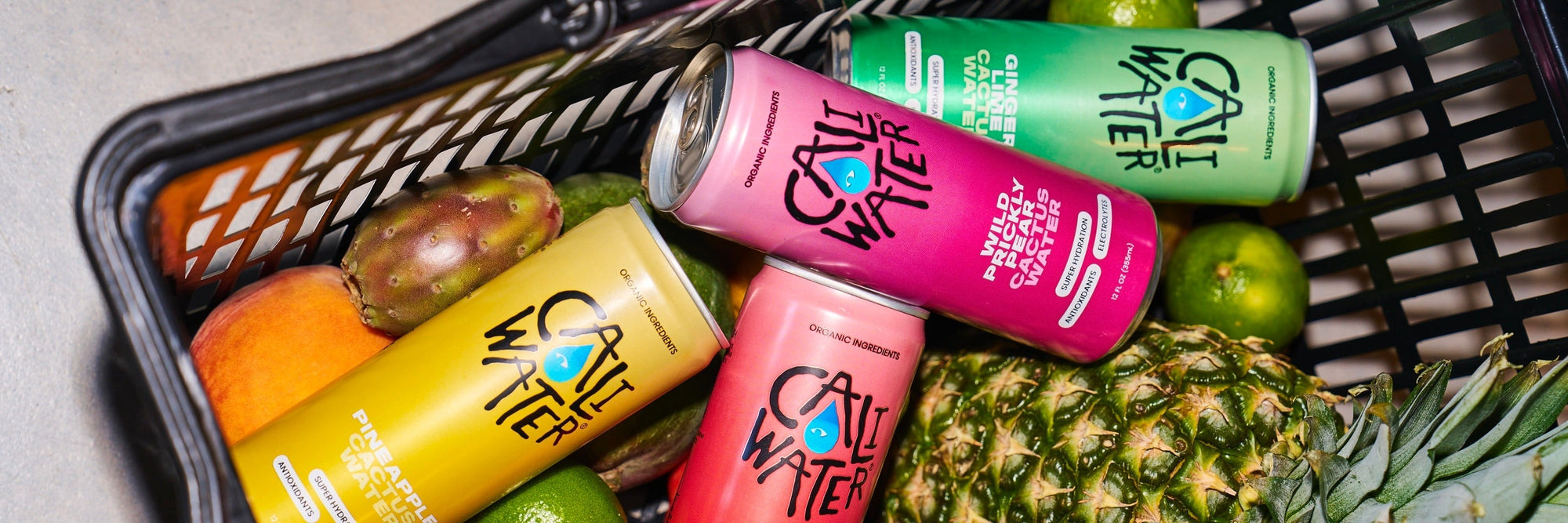 Grocery basket filled with Caliwater Cactus Water and fruit